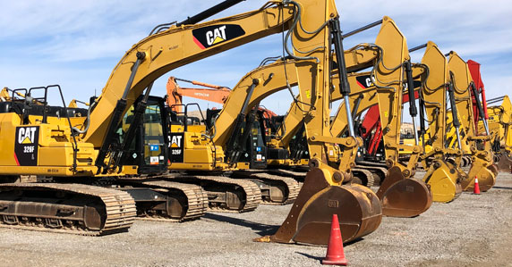 Caterpillar excavators at an auction yard Caterpillar excavators at an auction yard